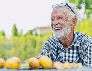 Man smiles outdoors