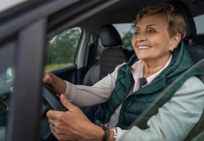 Older woman smiling while driving