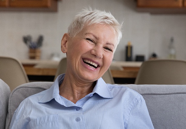 Smiling older woman after learning how dentures are made in Pittsburgh